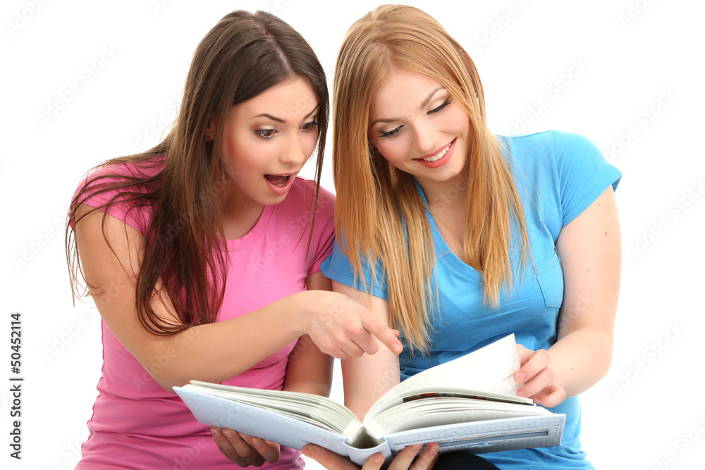 Two girl friends study isolated on white Two girl friends study isolated on white