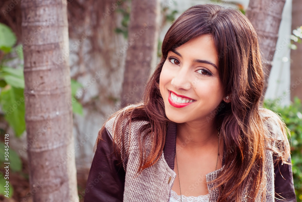 Portrait of a brunette woman smiling outdoors Portrait of a brunette woman smiling outdoors