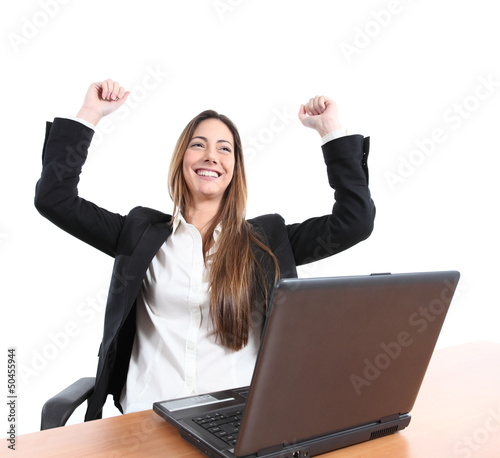 Euphoric businesswoman in an office with a laptop © Antonioguillem