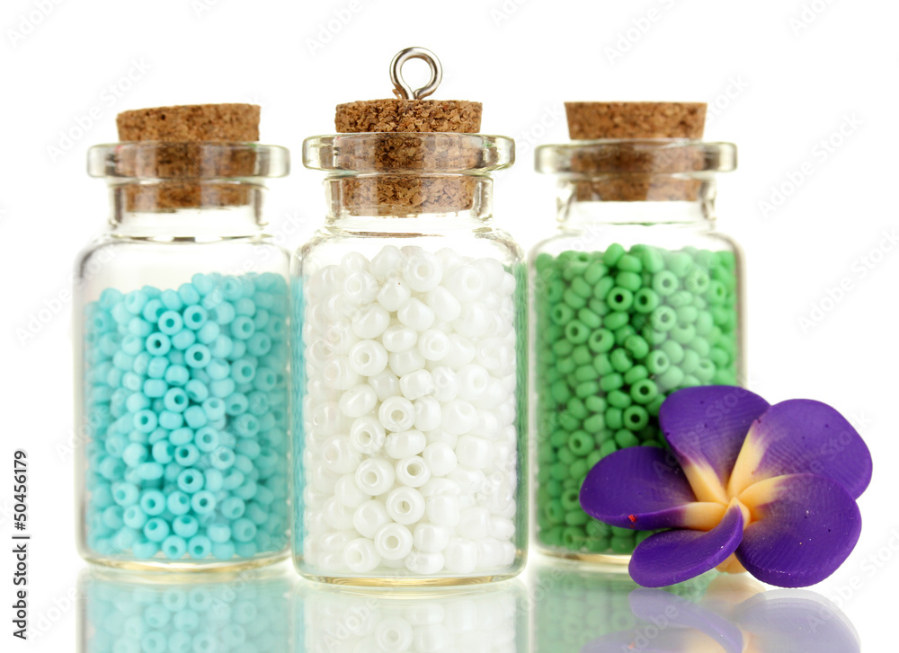 Little bottles full with colorful beads isolated on white