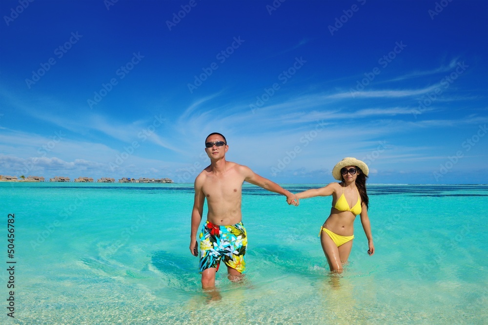 happy young  couple enjoying summer on beach