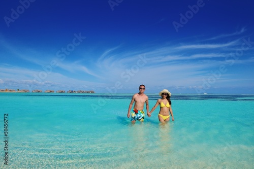 happy young couple enjoying summer on beach
