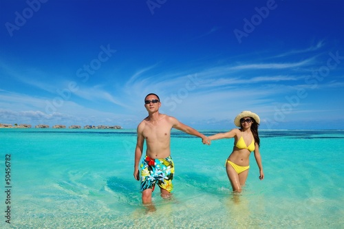 happy young couple enjoying summer on beach