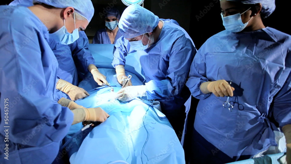 Specialized Team Performing Surgery in Operating Room Specialized Team Performing Surgery in Operating Room