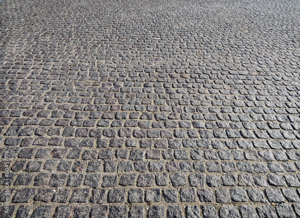 Closeup view on a cobblestone road - pattern - background Closeup view on a cobblestone road - pattern - background