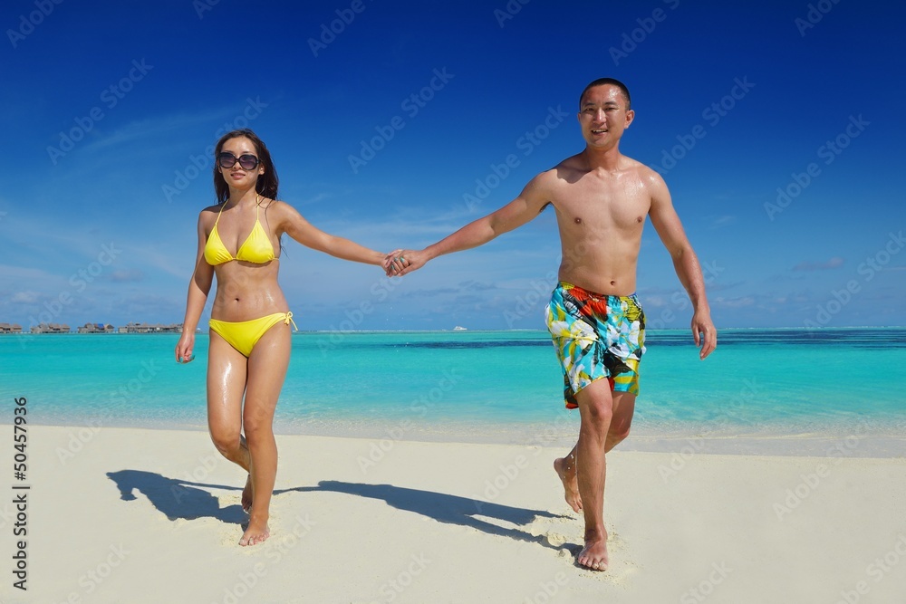 happy young couple enjoying summer on beach happy young couple enjoying summer on beach