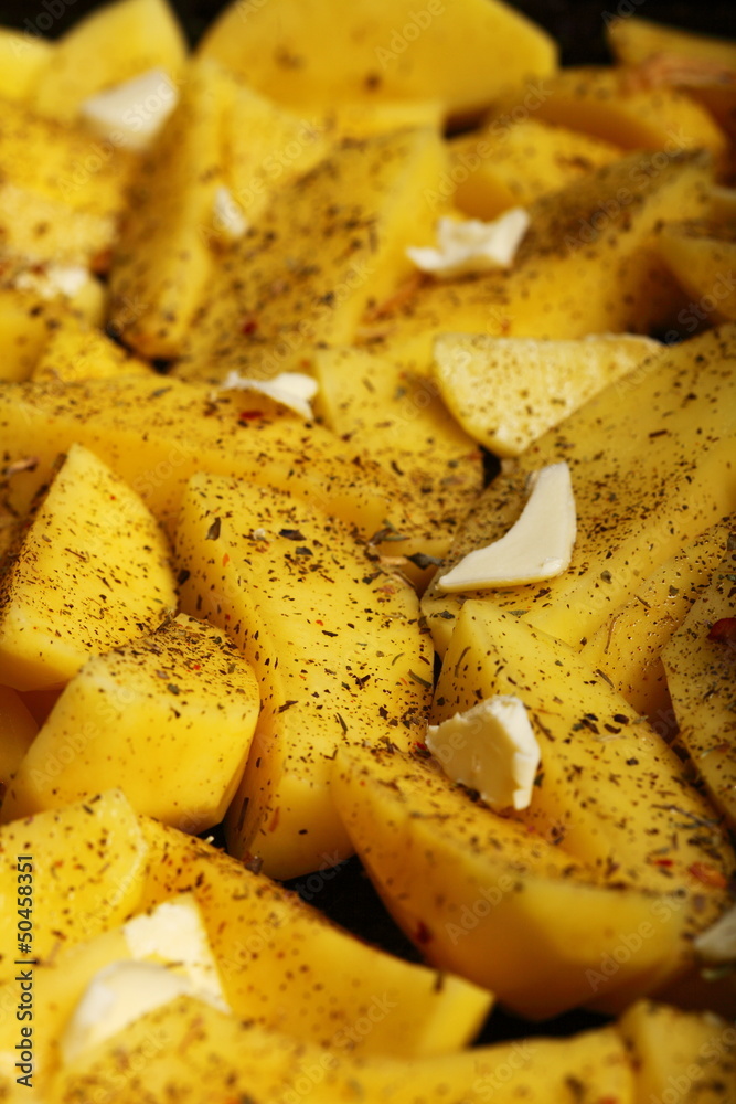 Raw potatoes with spices ready to be roasted Raw potatoes with spices ready to be roasted