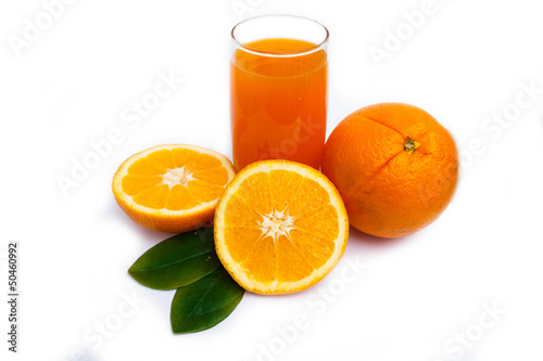 Orange juice and oranges on glass