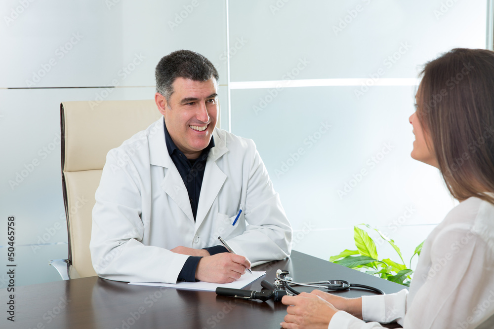Doctor man and patient woman on hospital office talking Doctor man and patient woman on hospital office talking