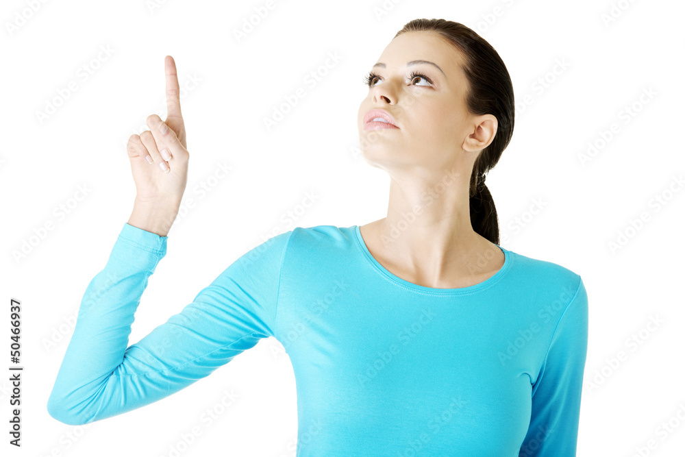 Happy , excited young woman pointing on copy space Happy , excited young woman pointing on copy space