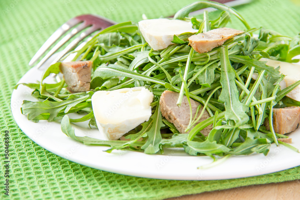 Salad with rucola, pork and brie cheese Salad with rucola, pork and brie cheese