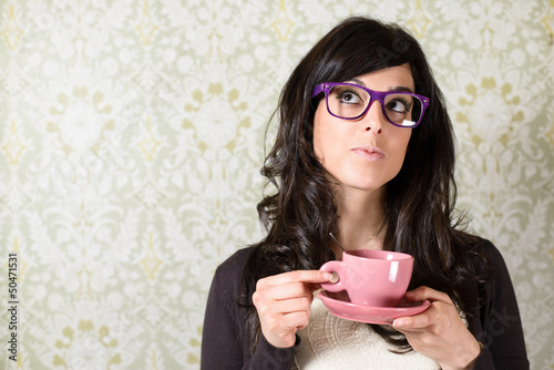 Woman thinking with cofffe cup photo