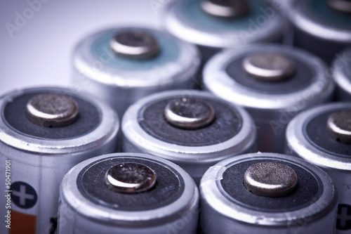 Several AA batteries in perspective closeup view on white backgr