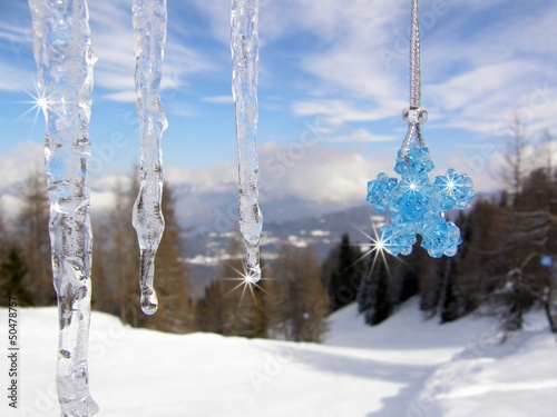 Icicles with blue crystal beads star in the mountains