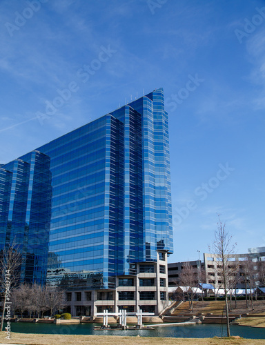 Blue Angled Office Tower by Lake