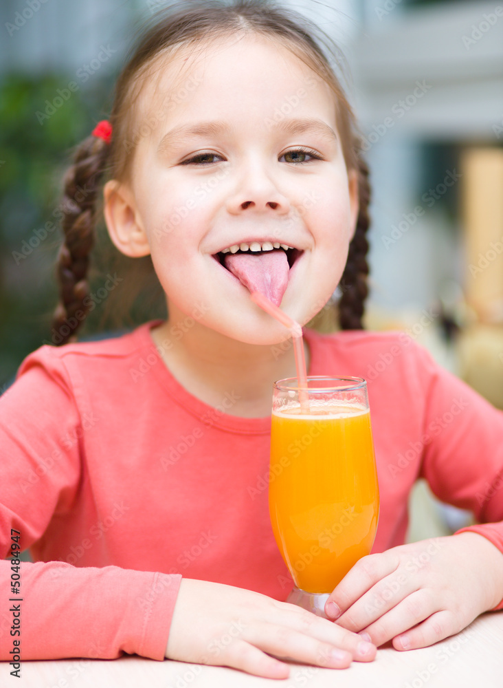 Little girl is drinking orange juice Little girl is drinking orange juice