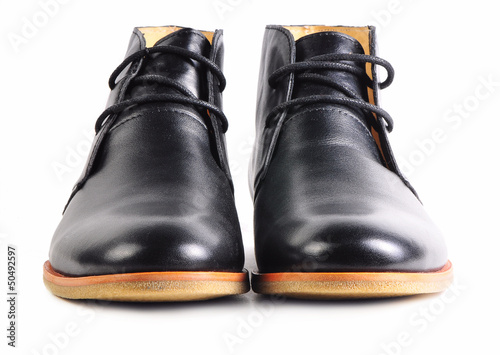 Pair of modern black leather shoes with laces isolated