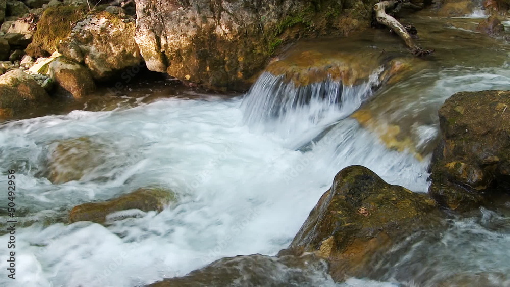 Beautiful mountain stream flowing through the green forest. Beautiful mountain stream flowing through the green forest.