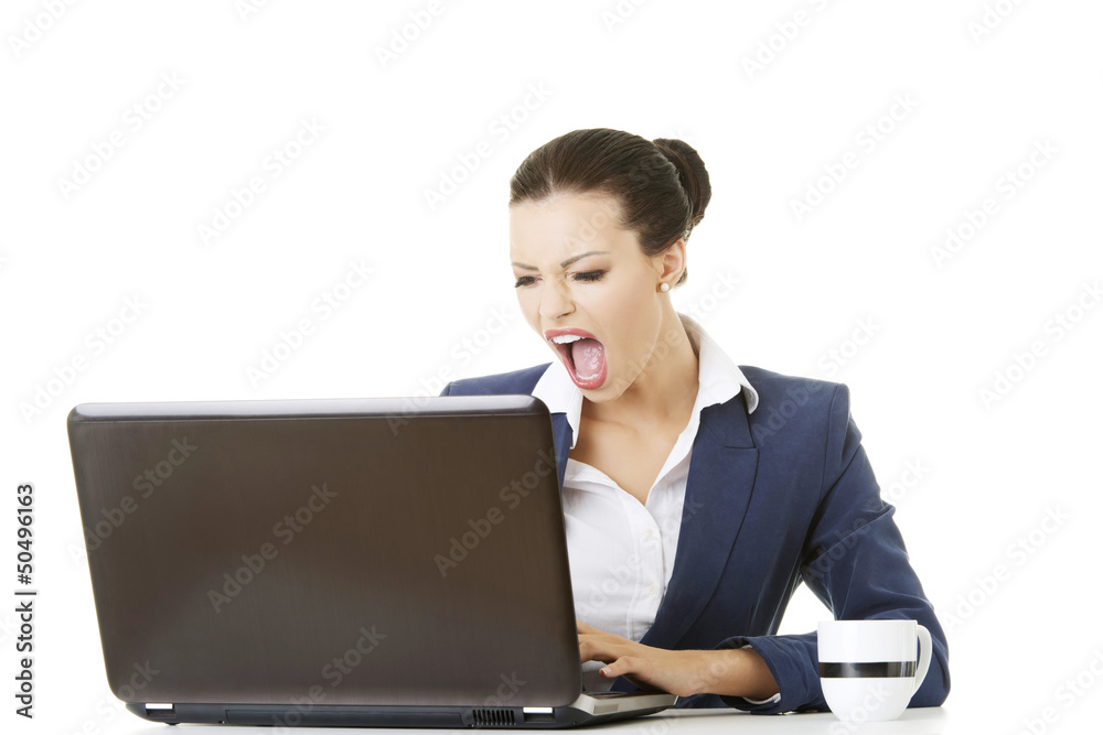 Angry businesswoman shouting on her laptop Angry businesswoman shouting on her laptop