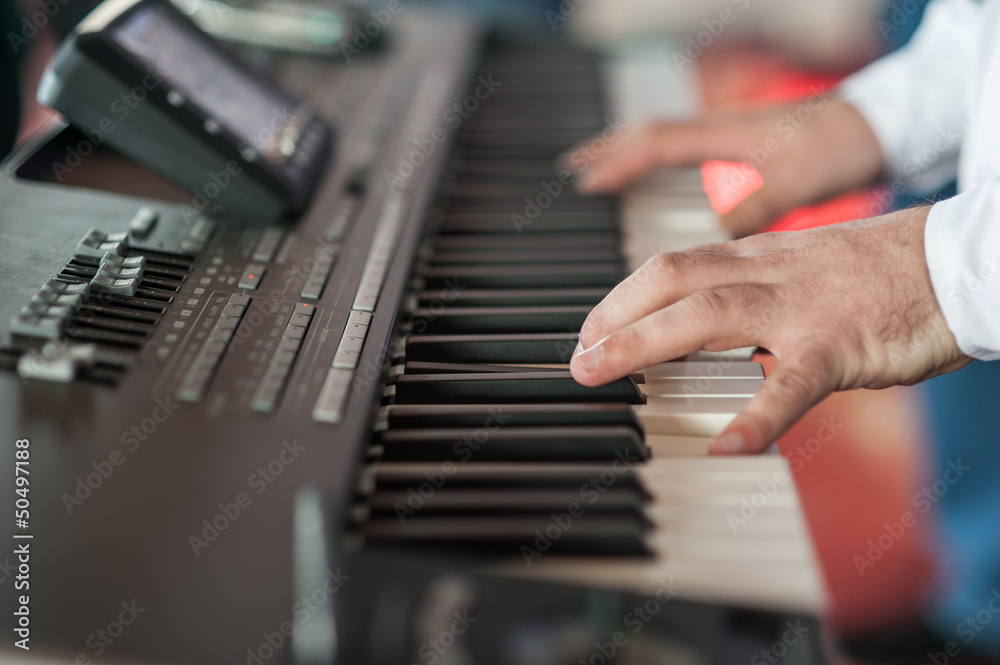 Fototapeta premium Musician playing on keyboards.Hands playing 