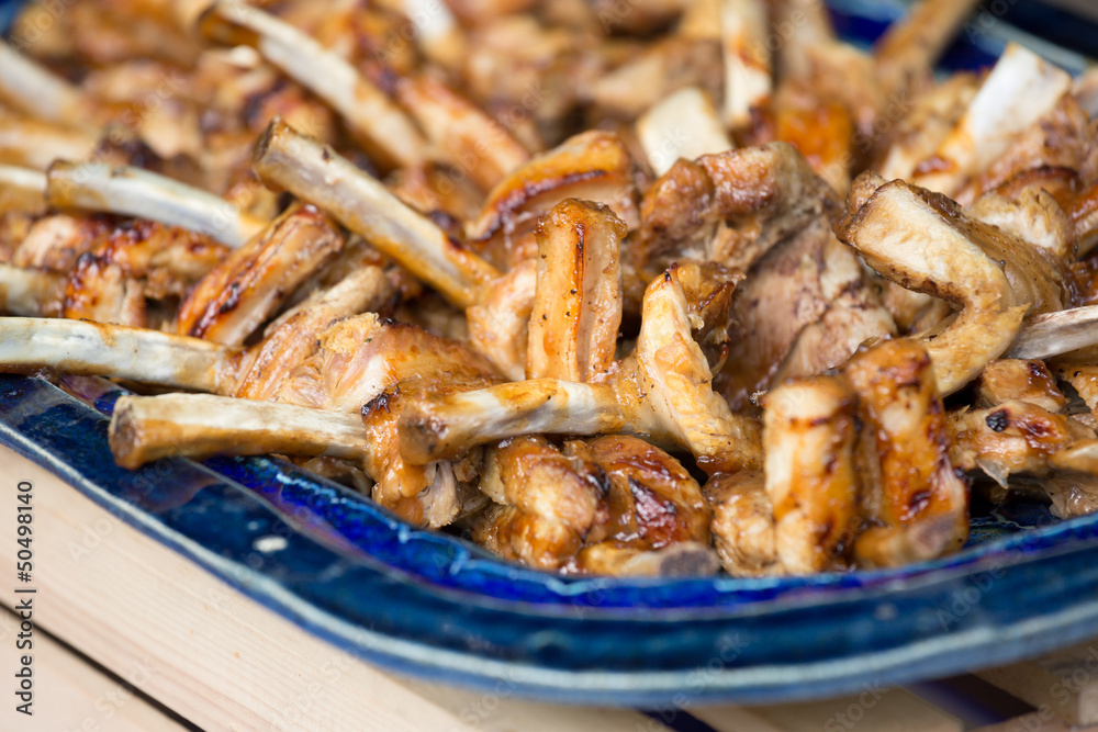 Delicious roasted pork chobs on a blue plate Delicious roasted pork chobs on a blue plate