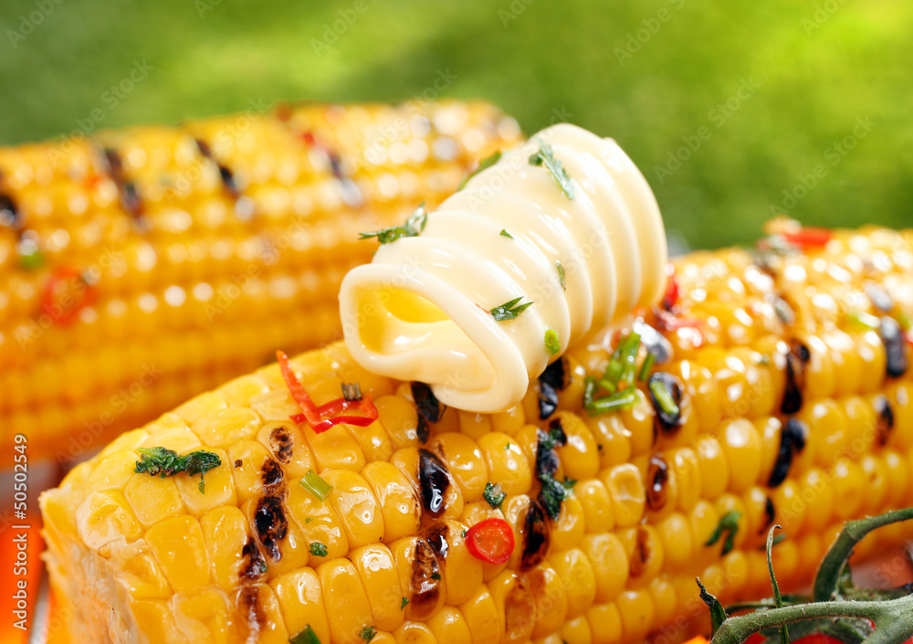 Fotografie Grilled corn on the cob with butter