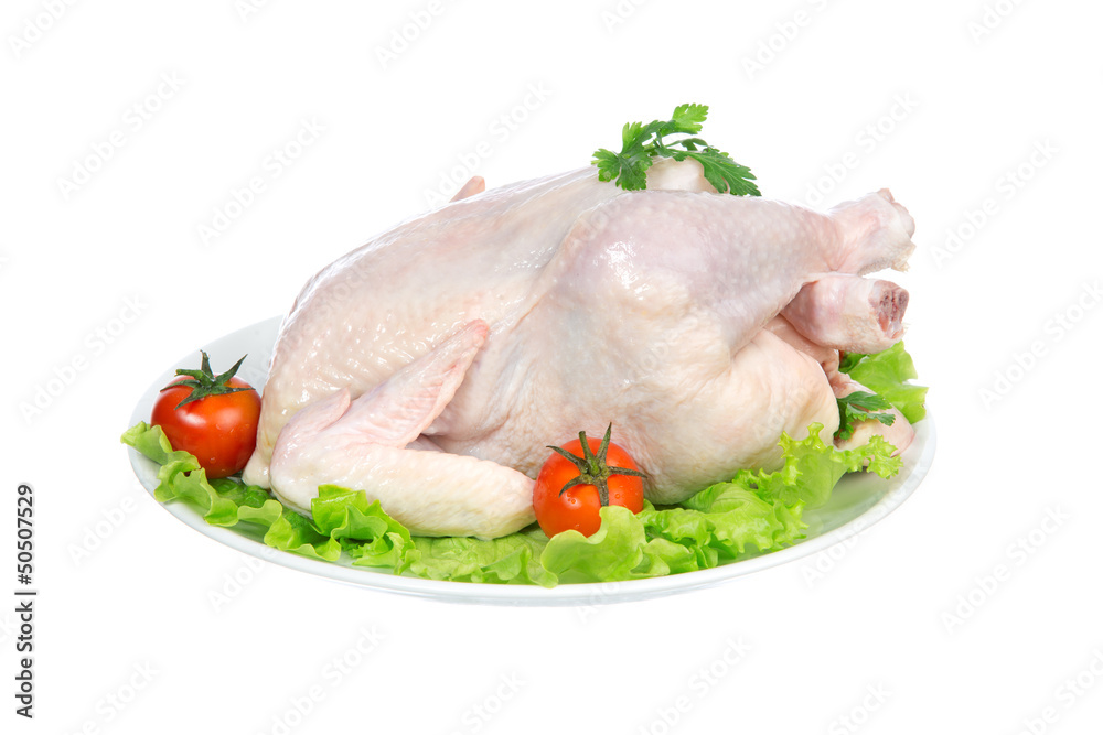 Raw crude chicken on a plate garnished Raw crude chicken on a plate garnished