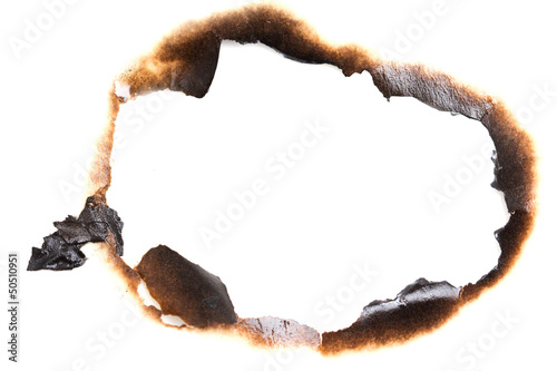 burned hole on a white paper background photo