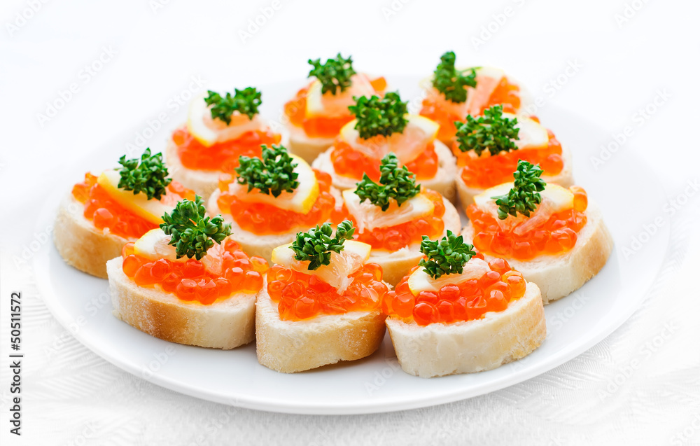 Canapes with salmon caviar, lemon and parsley Canapes with salmon caviar, lemon and parsley