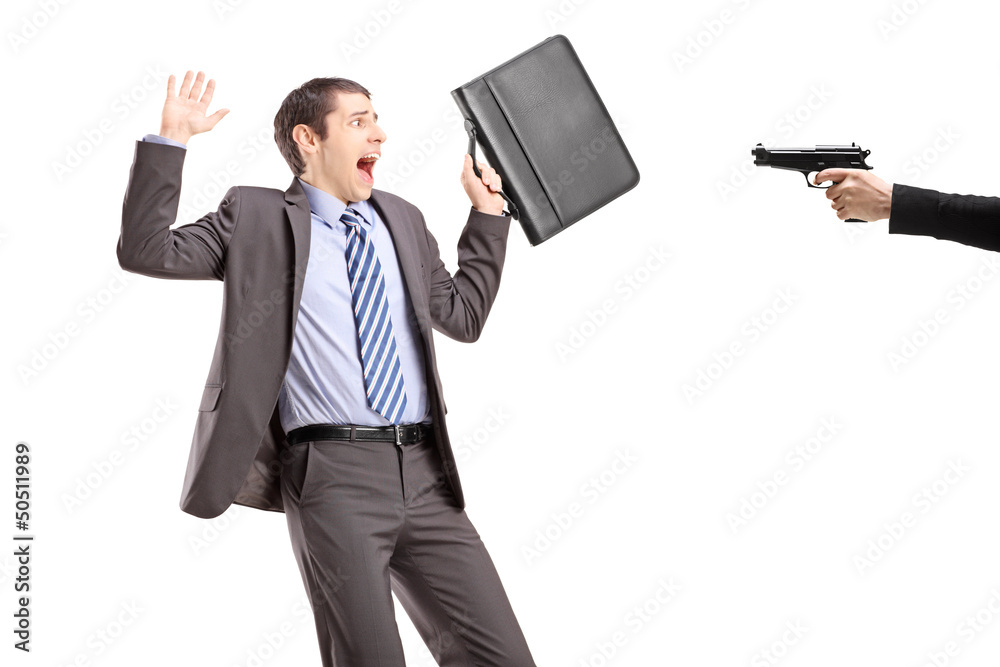 Scared businessman from a hand holding a gun Scared businessman from a hand holding a gun