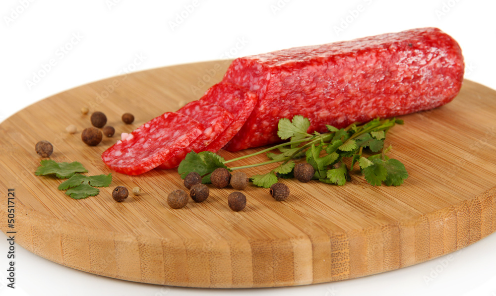 Tasty salami on wooden board isolated on white Tasty salami on wooden board isolated on white