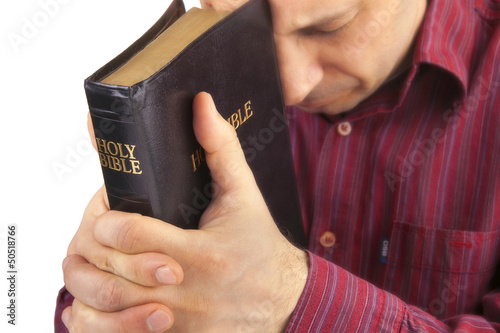 Photo Man Praying Holding the Bible