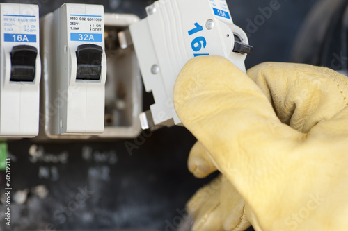 Electrician with electric fuse at switch board