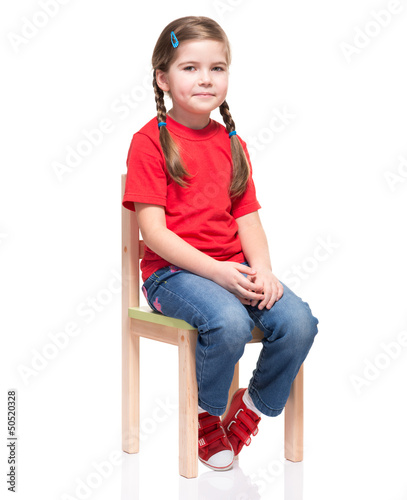 little girl wearing red t-short and posing on chair
