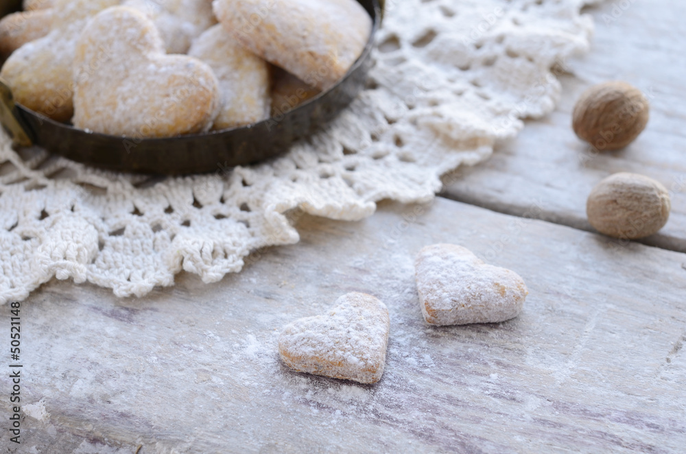 Homemade heart shaped cookies on wooden background in vintage st