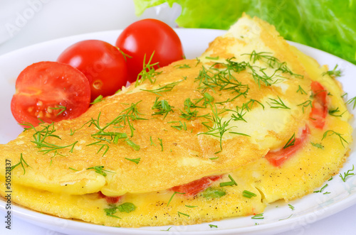 Omelet with herbs and vegetables on the plate