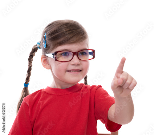 little girl wearing glasses and pointing by forefinger to somewh
