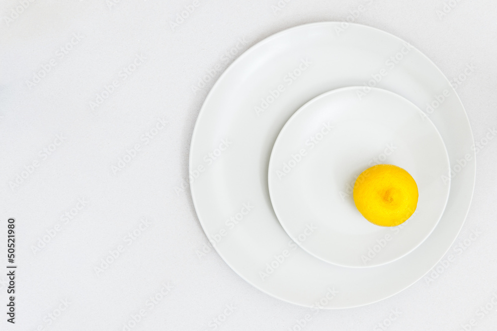 Fresh lemon on two white plates Fresh lemon on two white plates