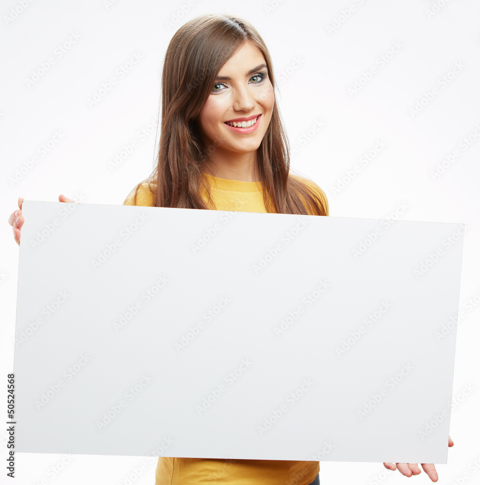 Teenager girl hold white blank paper. Young smiling woman show b Teenager girl hold white blank paper. Young smiling woman show b