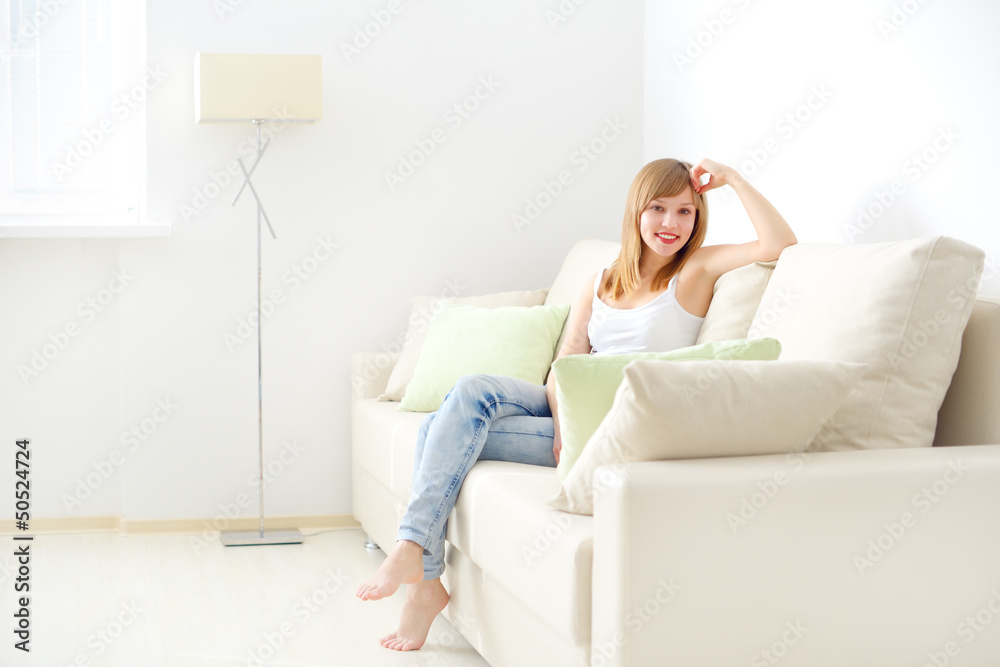 smiling girl sitting on sofa