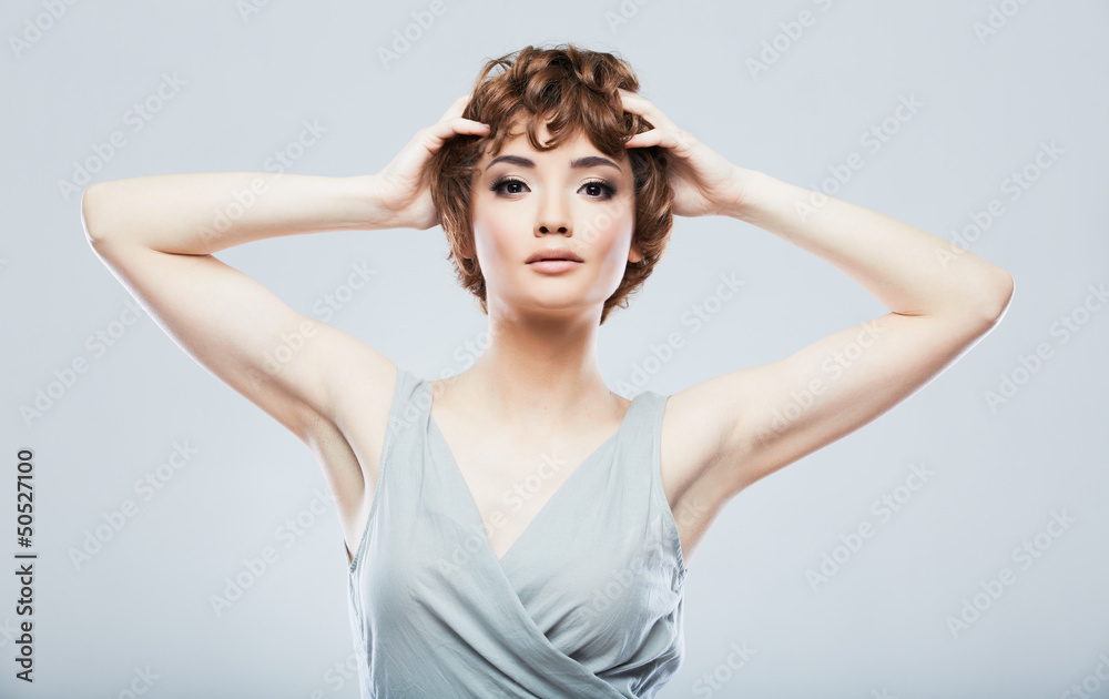 Beautiful woman standing against studio background.