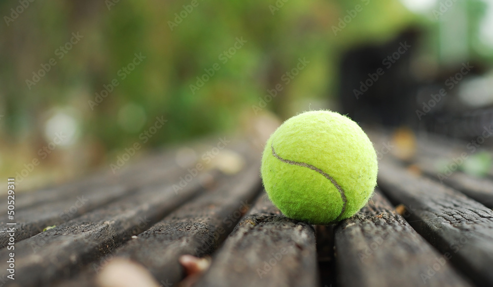 tennis ball on wood floor