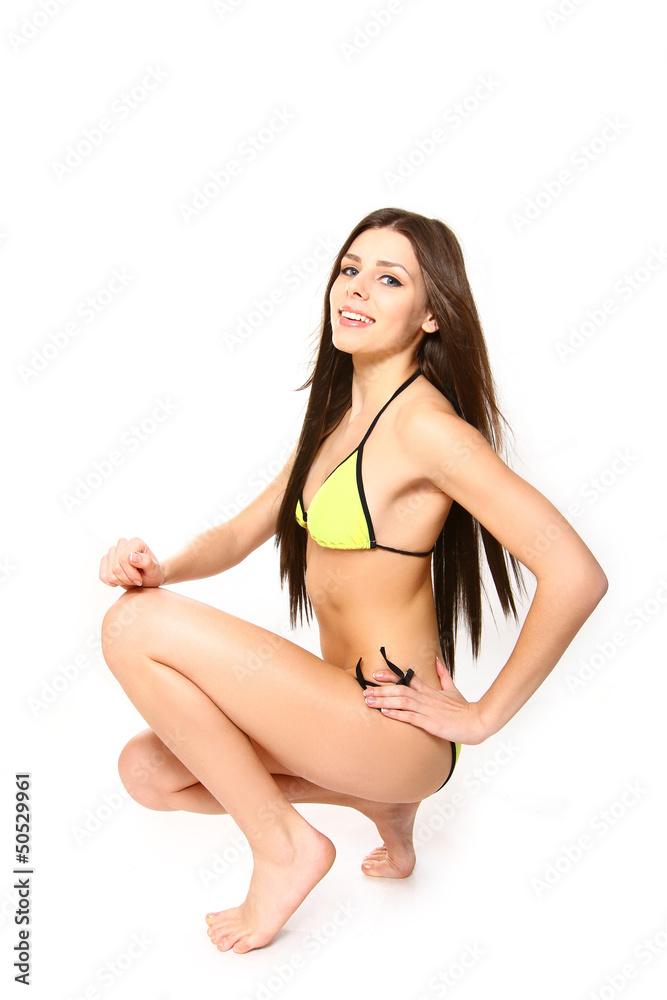 Fototapeta premium Young woman in a swimsuit on a white background