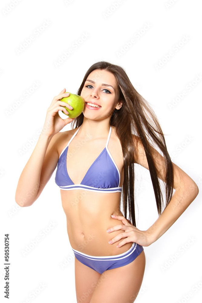 Sexy woman standing in bikini with apple on white background Sexy woman standing in bikini with apple on white background