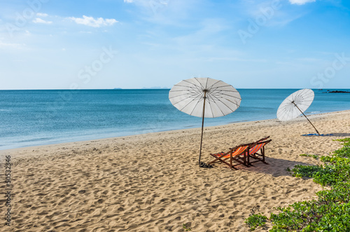 Deckchairs and Parasols on a solitary Beach
