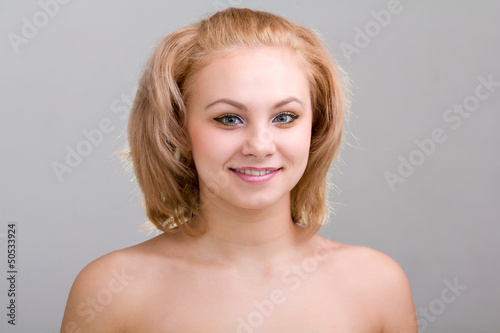 smiling woman on gray background