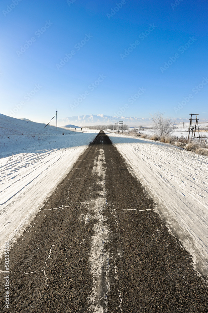 Winter asphalt road to the mountains