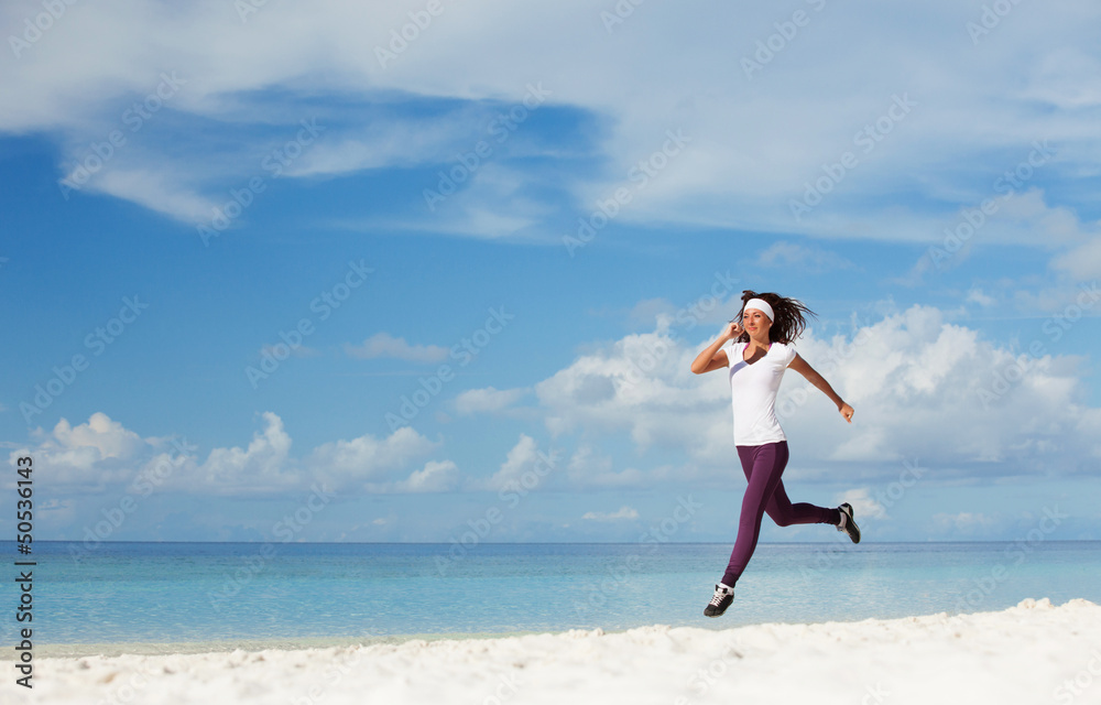 Young woman running on the beach Young woman running on the beach