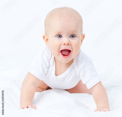 Portrait of a cute tiny blue eyes surprised baby