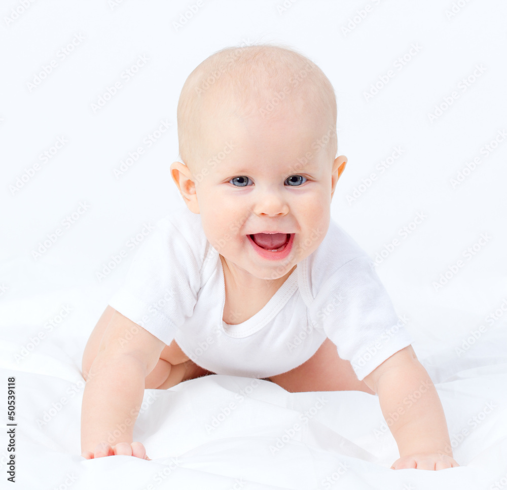 Portrait of a tiny blue eyes baby girl crawling with open mouth